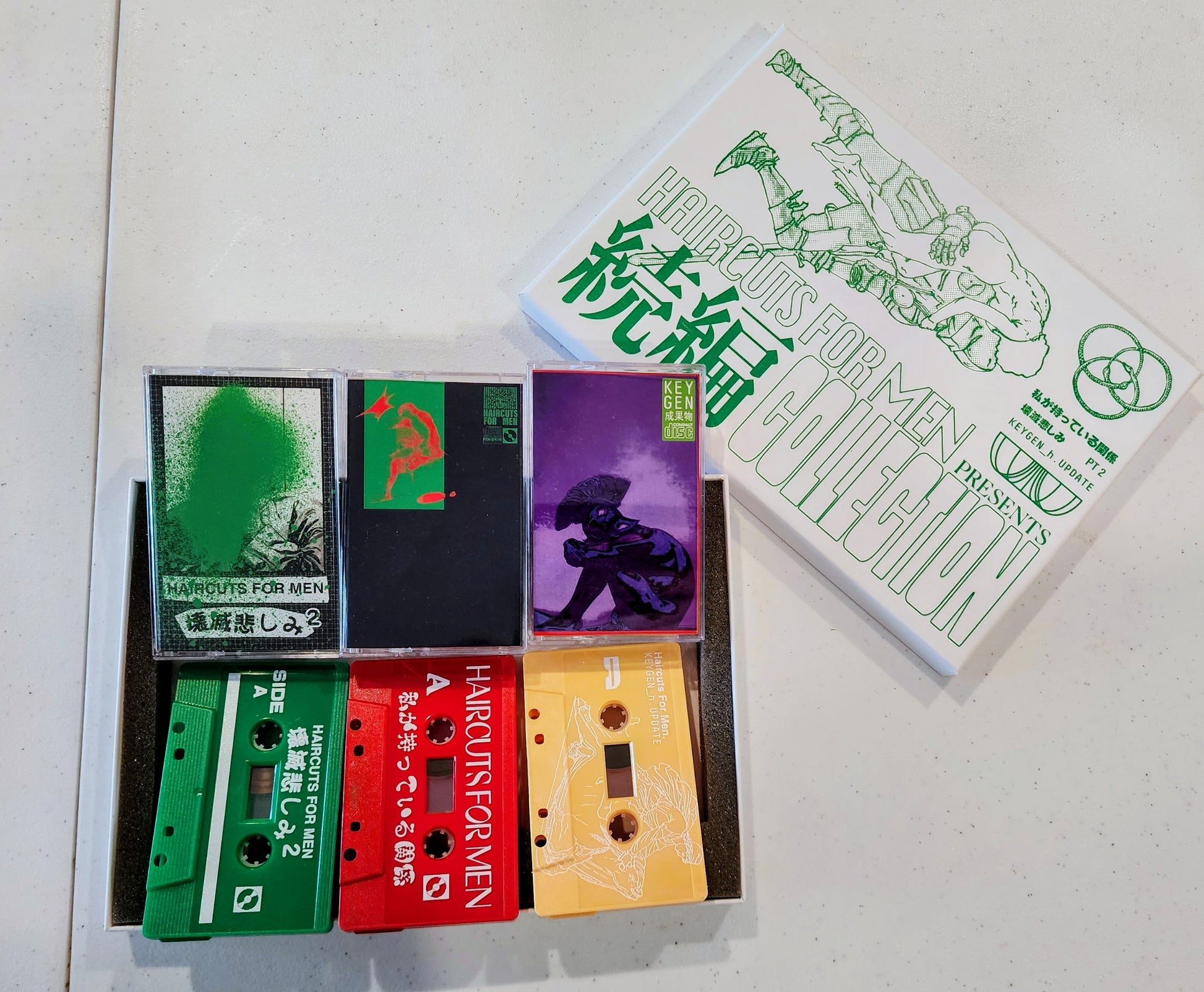 Collection of cassette tapes with colorful labels on a white background.